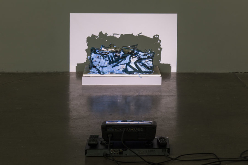 Bessie Kunath Plastic Parts Block in Blue digital video projection over sculpture