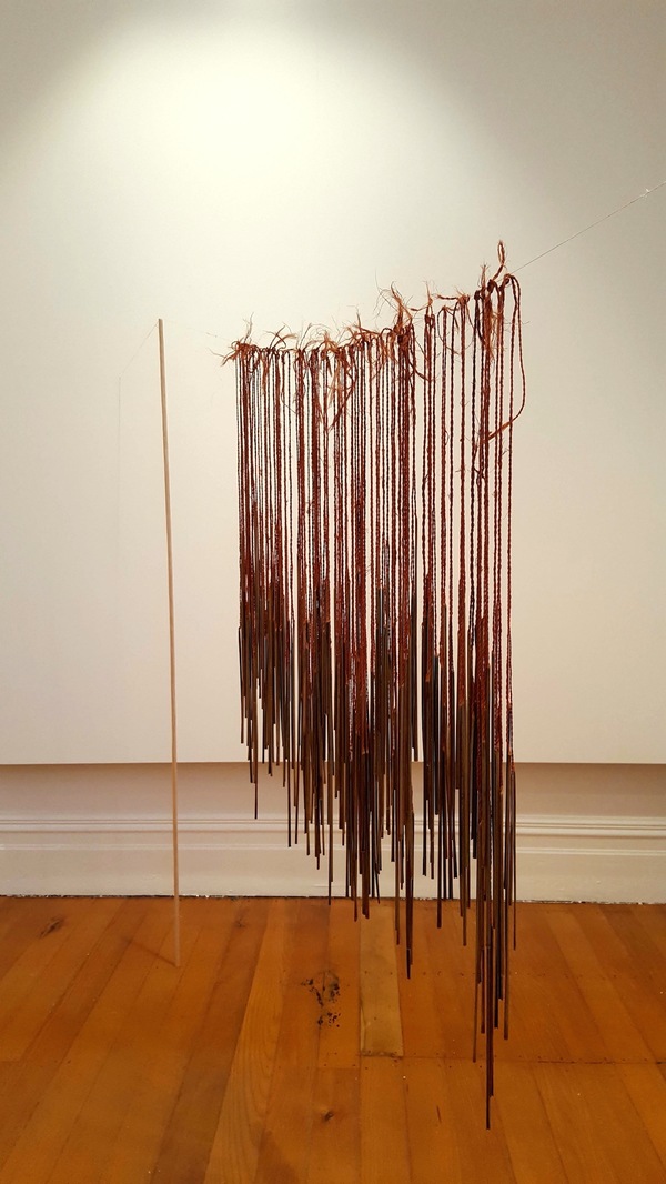 Michelle Mayn 2019 - Journeys Between Two Places Muka aho/thread (NZ Flax fibre), pokinikini tags, hand-whittled dowel