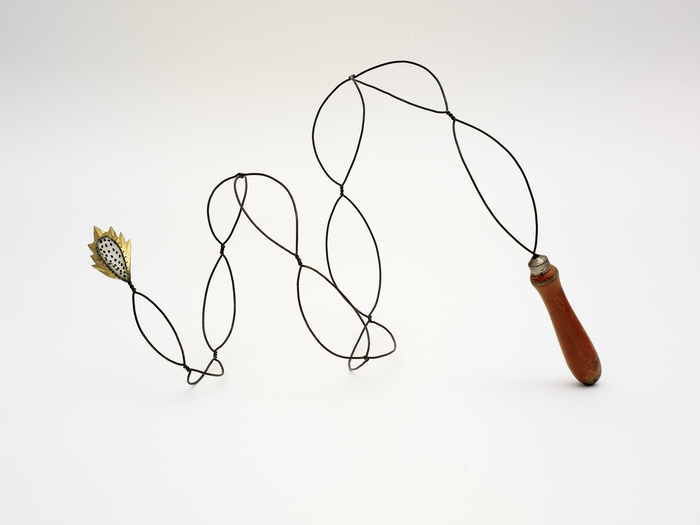  Pam J. Brown Sculpture 14 ga. steel wire, brass foil, seeds, wooden handle.